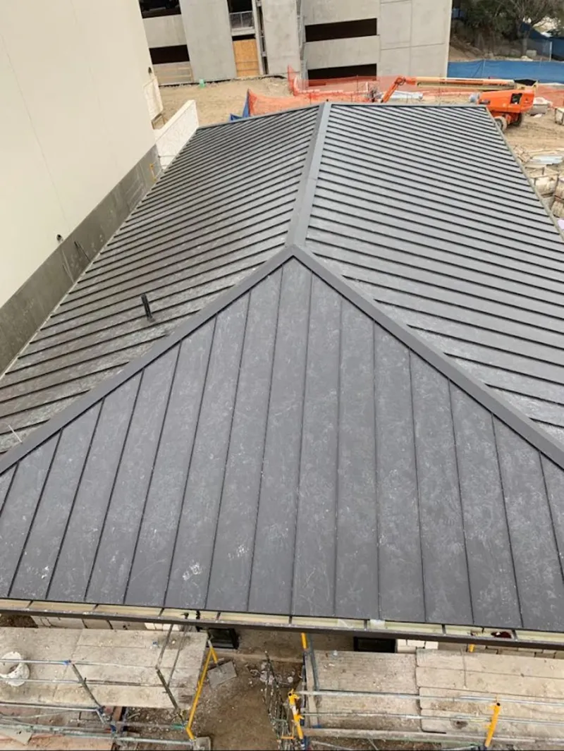 Commercial metal roof construction with crane equipment in Highland Heights